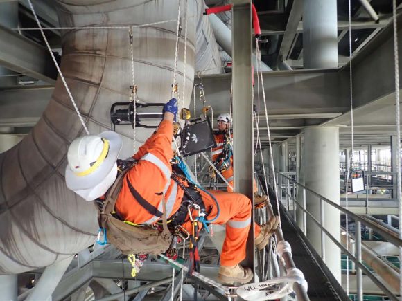 Operators installing Teledyne ICM battery-operated X-ray generator, CP160B and X-ray digital detector, Go-Scan 4335 to perform an inspection © Kaefer Australia
